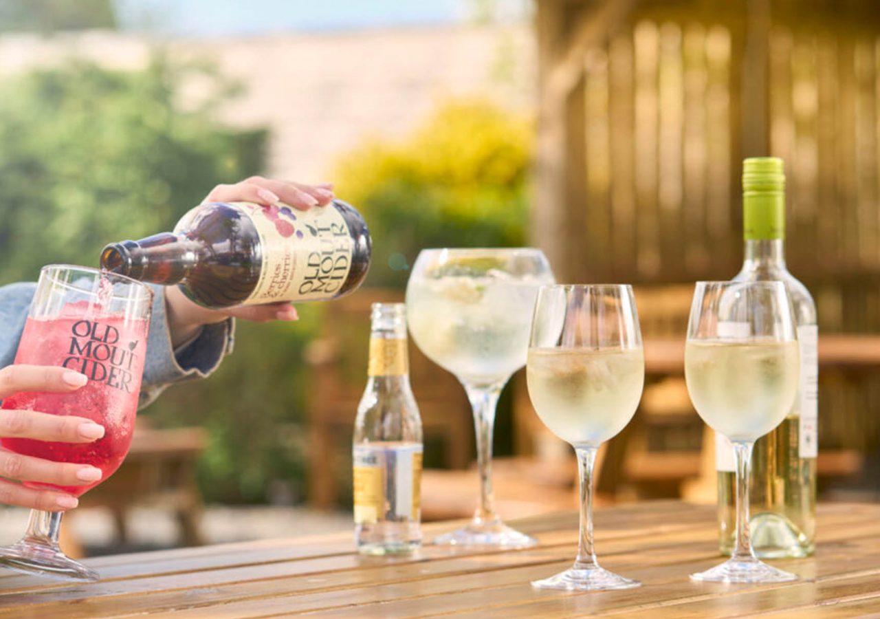 A person pouring drinks in the beer garden at The Ulbster Arms Hotel