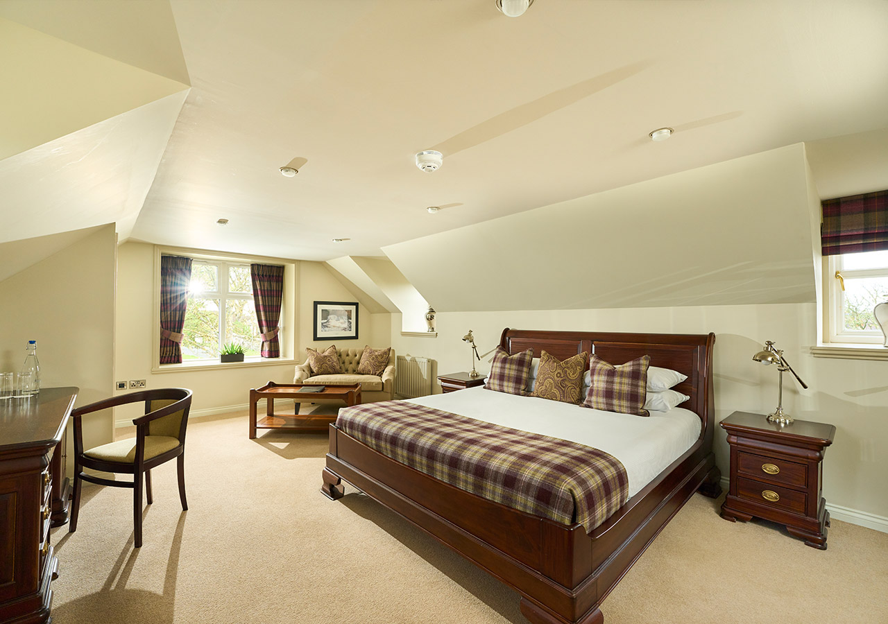 An Executive Room type in the Ulbster Arms Hotel in Caithness with mahogany furnishings and sofa