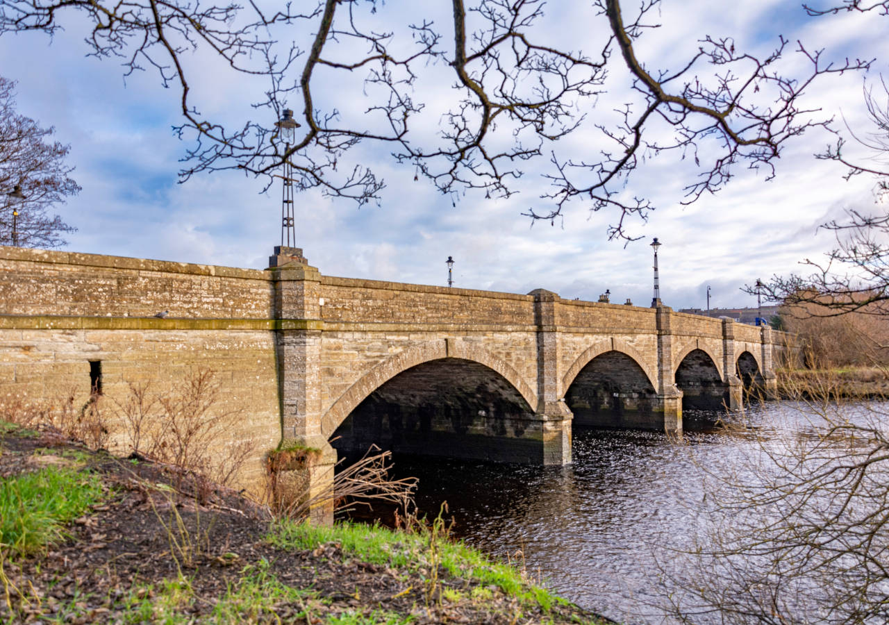 Arched stone bridge over the river in winter at Thurso