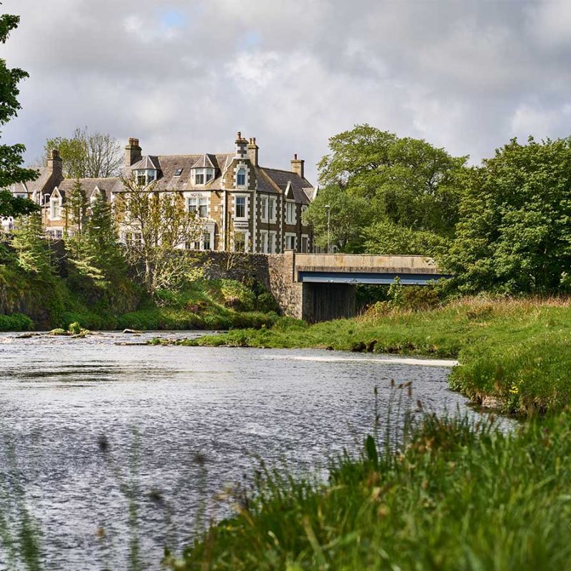 A view of the Ulbster Arms Hotel in Caithness from the river in front of it