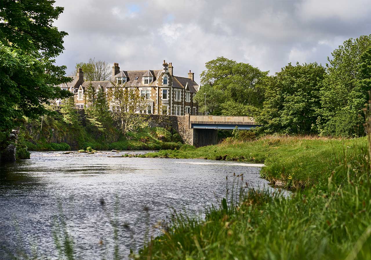 A view of the Ulbster Arms Hotel in Caithness from the river in front of it