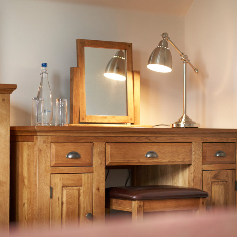 Desk and lamp in a hotel bedroom