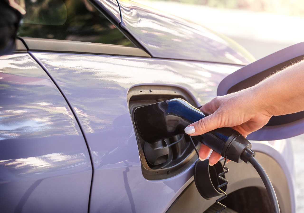 Close up of EV charger and car